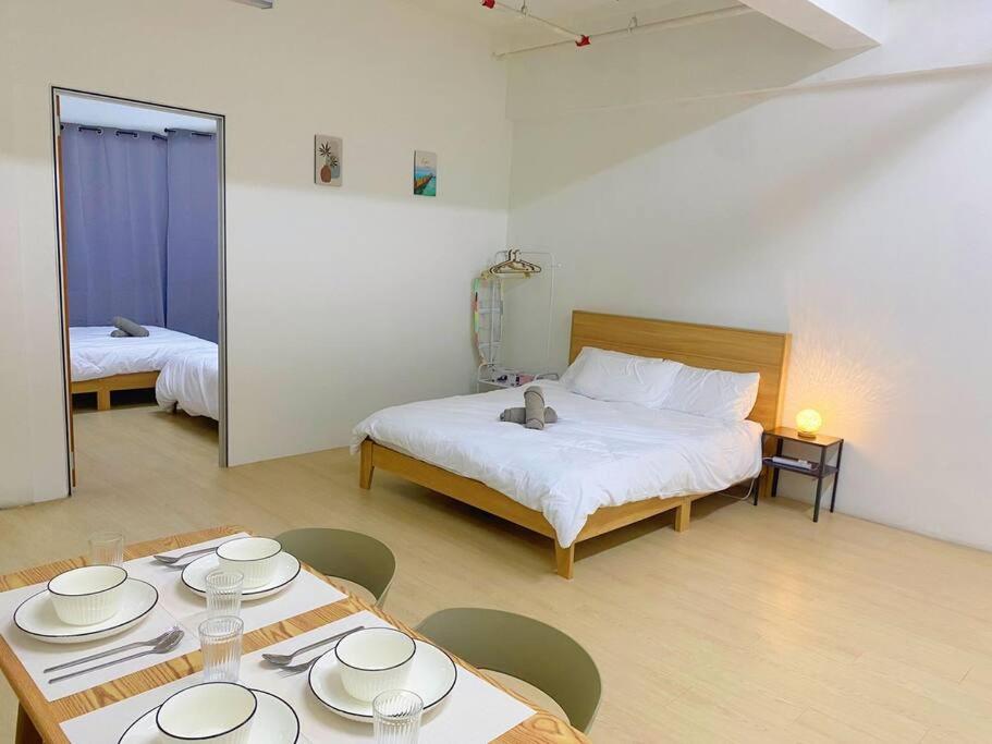 a room with a bed and a table with plates on it at S2 Muji Sunway Geo 1-8pax Sunway Medical Centre in Petaling Jaya