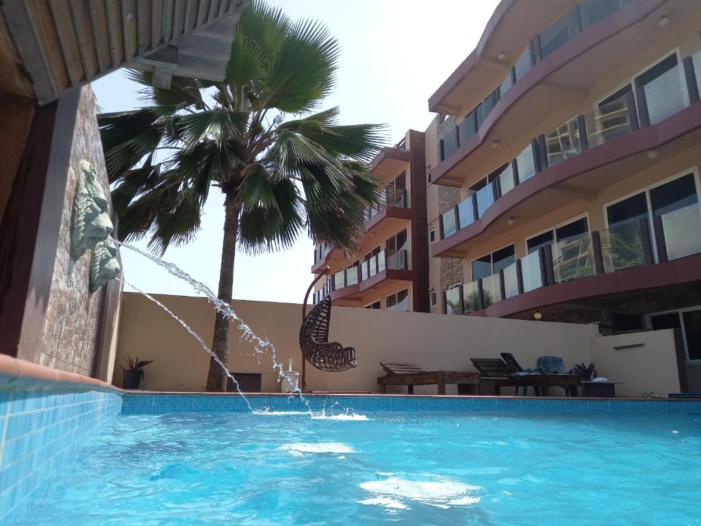 a swimming pool in front of a hotel at LA SUNSET in Accra