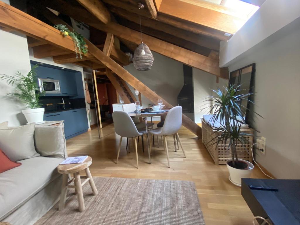 a living room with a couch and a table at loft de la place in Bourg-Madame