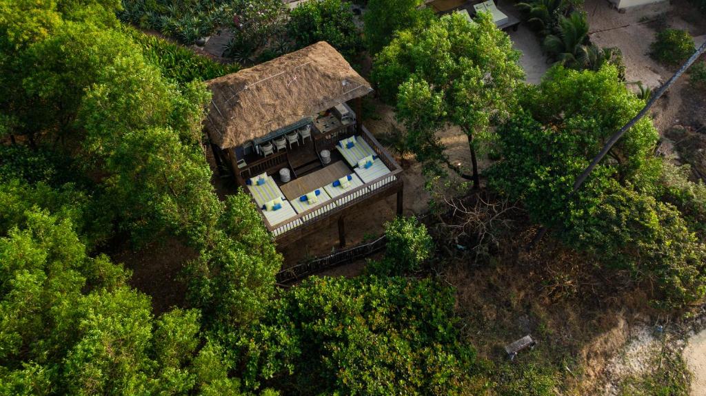 an overhead view of a house in the middle of trees at SaffronStays Stella Maris - Luxury Beach Front Villa Near Redi Beach in Querim