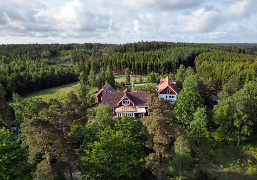 an aerial view of a house in the woods at Escape to PaulssonPaleo in Simlångsdalen