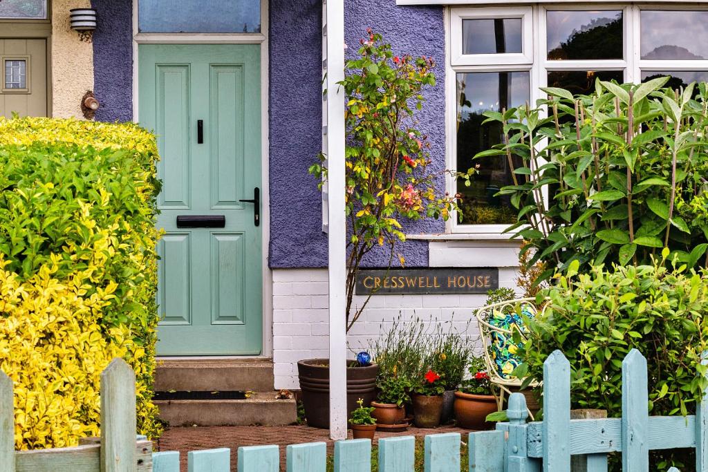 a purple house with a green door and a fence at Finest Retreats - Cresswell House in Cresswell