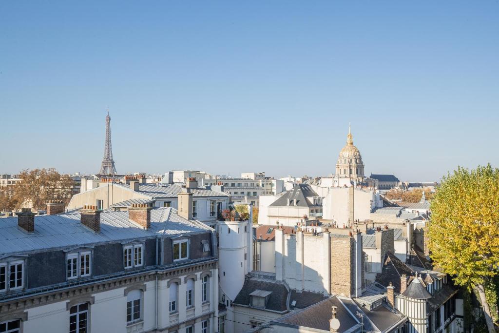 a view of a city skyline with buildings at Eiffel Tower view terrace Saint Germain des Pres in Paris