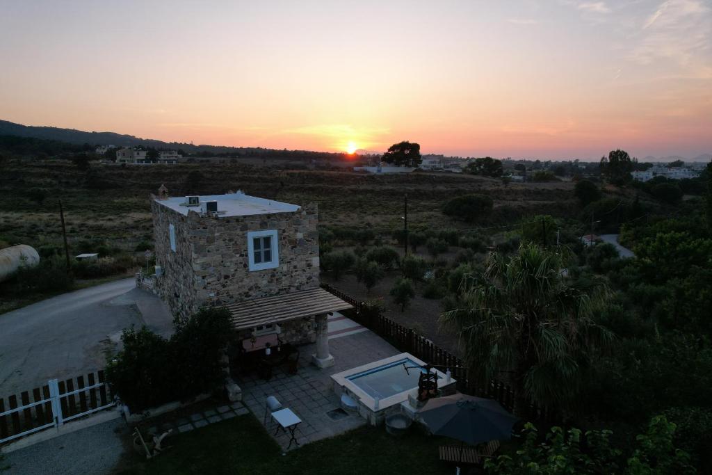 an aerial view of a house with a swimming pool at Traditional Kos villa with swimming pool, lawn yard and bbq in Kos Town