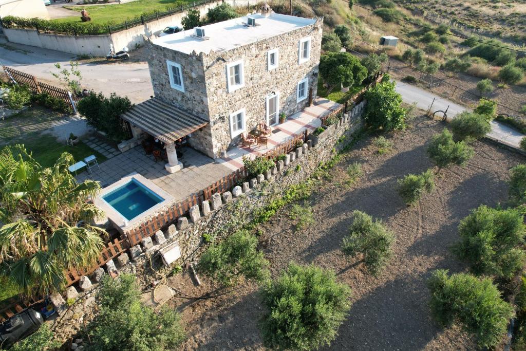 an aerial view of a stone house with a swimming pool at Traditional Kos villa with swimming pool, lawn yard and bbq in Kos Town