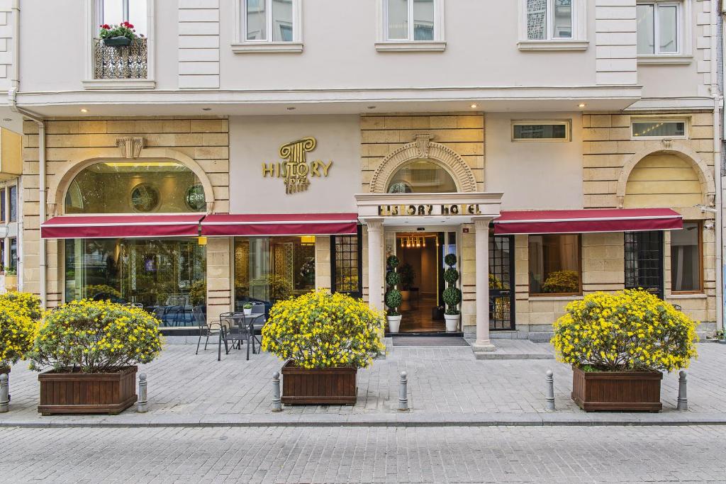 a hotel with flowers in front of a building at History Hotel in Istanbul