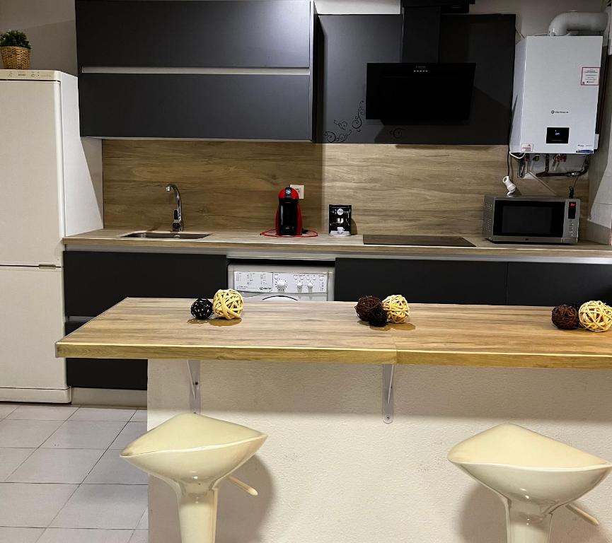 a kitchen with a counter with two stools in it at San Andres in Zamora