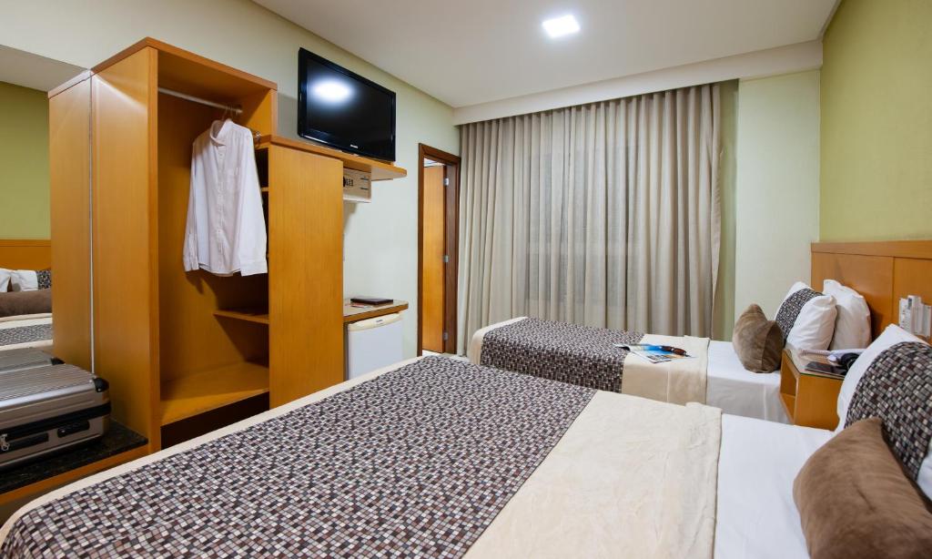 Postel nebo postele na pokoji v ubytování Hotel Santorini