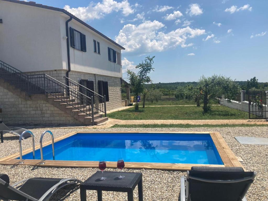 a swimming pool in front of a house at Casa Cerin with Private Pool in Barat