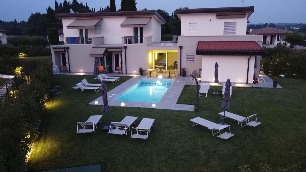 an aerial view of a house with a swimming pool at B&B Lough in Colà di Lazise