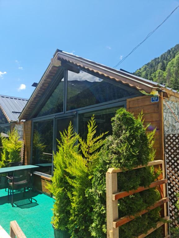 a house in the mountains with a swimming pool at Yayla Bungalov in Ayder Yaylasi