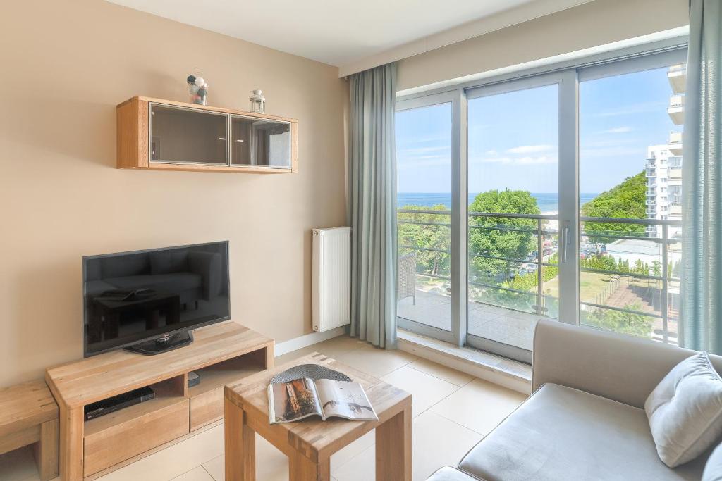 Televízia a/alebo spoločenská miestnosť v ubytovaní Your Holidays Promenada Gwiazd 28