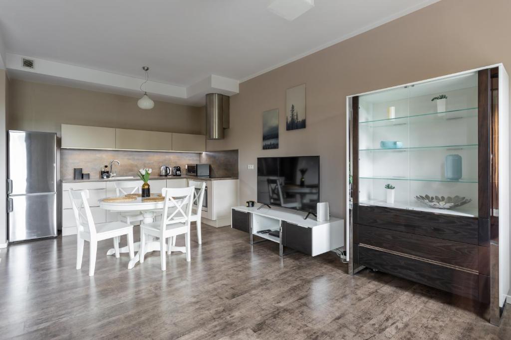 a kitchen and dining room with a table and chairs at Golden Apartments Warsaw - Big Luxury Apartment in the Center - Kolejowa in Warsaw