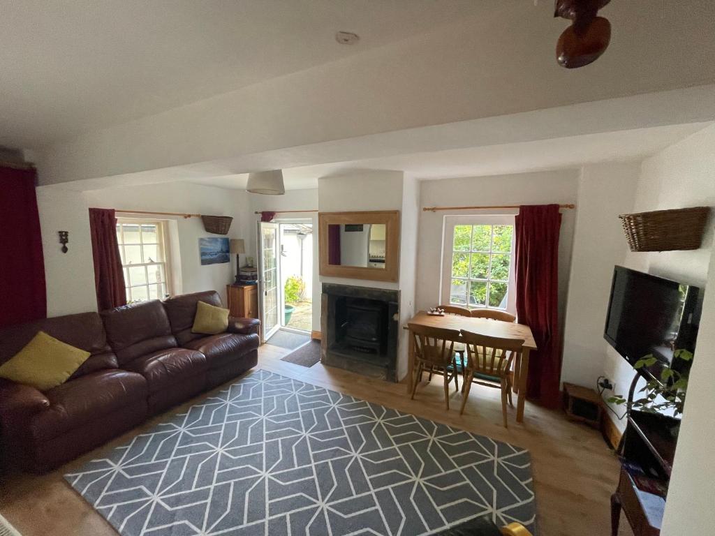 a living room with a couch and a table at Robinsons Cottage, central and quiet in Cockermouth