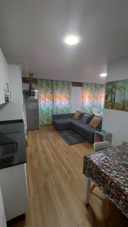 a living room with a couch and a table at Apartamento Céntrico cerca de la playa in Bueu