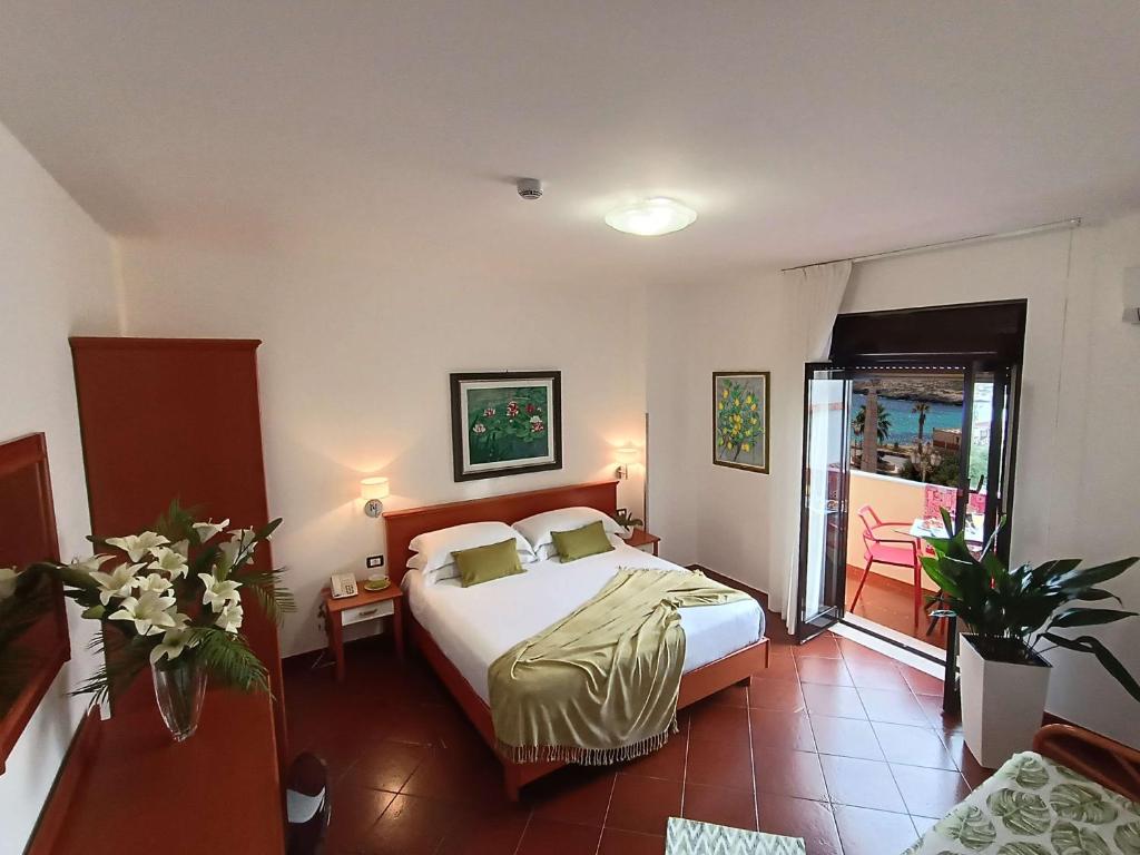 a hotel room with a bed and a balcony at Best Western Hotel Martello in Lampedusa