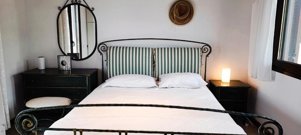 a bedroom with a bed with a wrought iron headboard at Trikorfo Bungalows in Gerakini