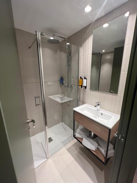 a bathroom with a sink and a shower at Hotel H4 Cangas 3 Superior in Cangas de Morrazo