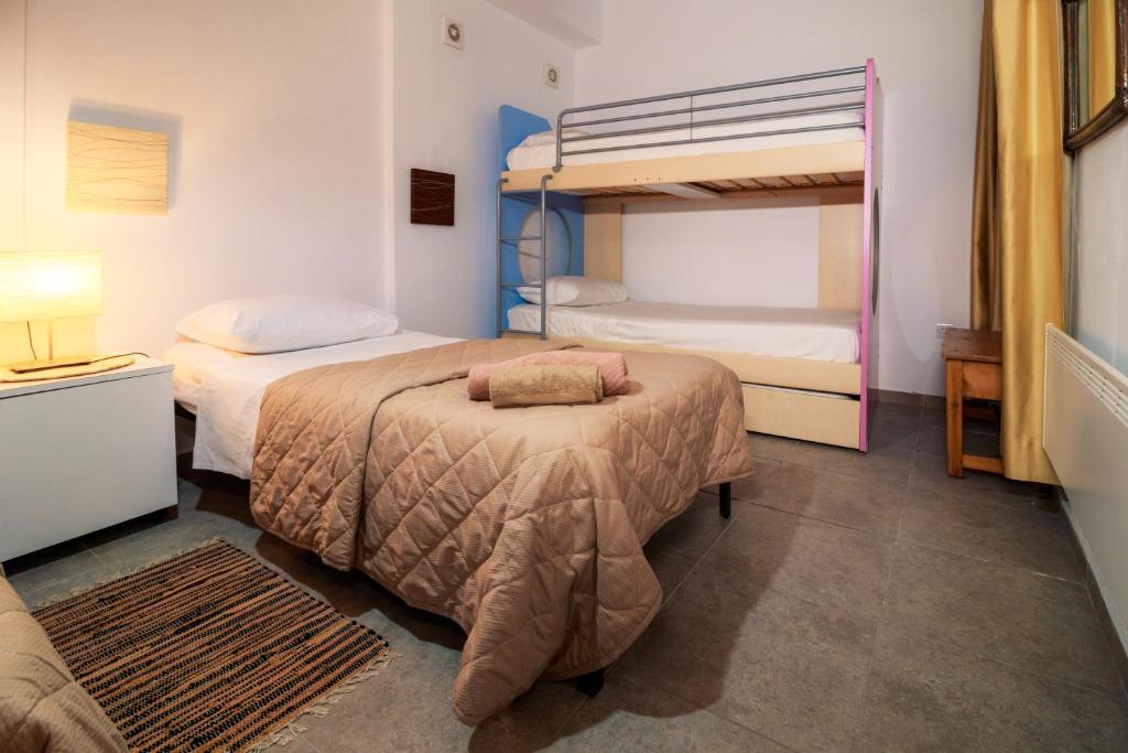 a bedroom with two beds and a bunk bed at Stella's Country House in Prodromos