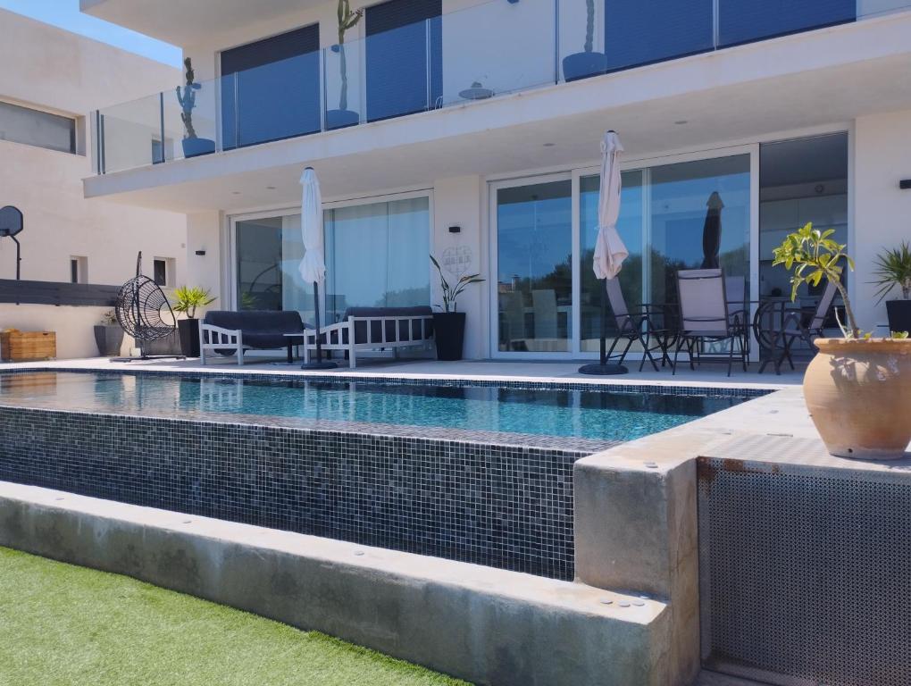 a swimming pool in the backyard of a house at Ca Na Xisca in Felanitx