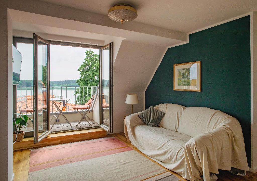 a living room with a couch and a large window at Sommerfrische Lychen in Lychen