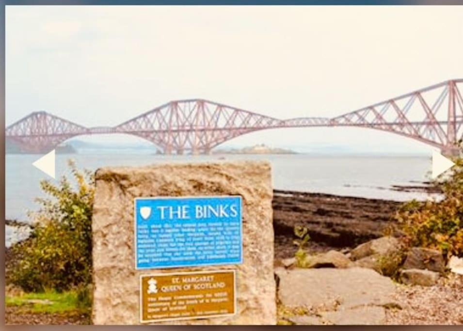 a blue sign in front of a bridge at 3 Bedroom harbourside apartment, Queensferry, 10 miles from Edinburgh in Queensferry