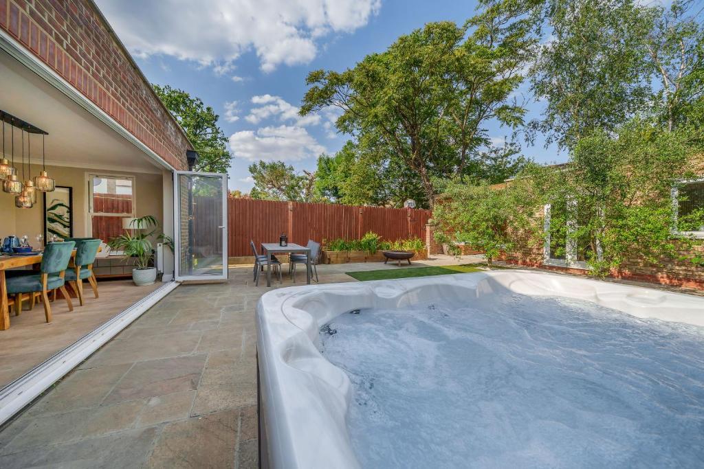 a hot tub in the backyard of a house at Stunning 3B2Ba Huge entertaining space and hottub! in Raynes Park