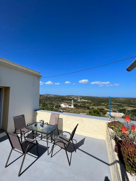 a patio with a table and chairs on a balcony at Drymonas cottage in Kythira