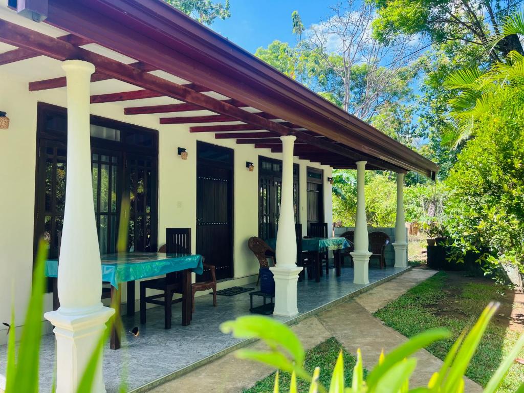 a house with a ping pong table on a patio at Harini Villa in Sigiriya