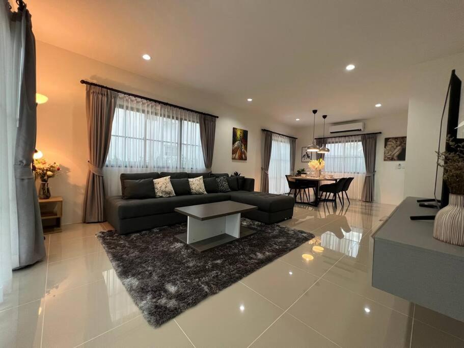 a living room with a couch and a table at MOST Family 456/66 Ubon-Thailand in Ubon Ratchathani