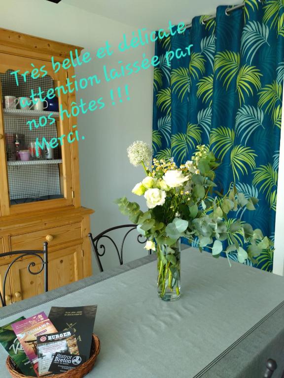 a vase of flowers sitting on a table at C La Belle Vie in Pessac