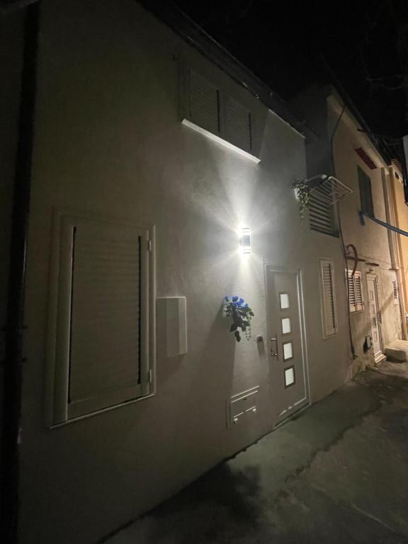 een persoon staat 's nachts buiten een deur bij gler_house in Ischia