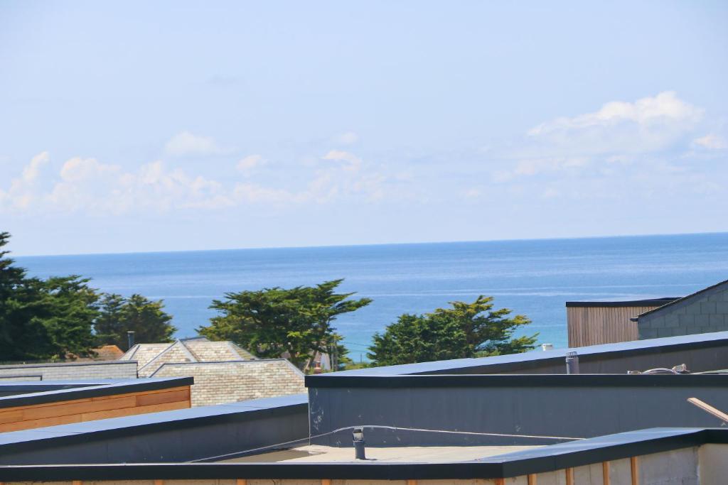 a view of the ocean from the roof of a building at Coastal apartment sea views in Saint Merryn