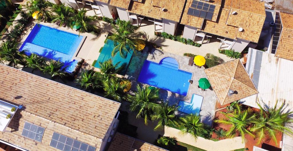 an overhead view of a resort with palm trees and pools at Pousada Vitalis in Olímpia