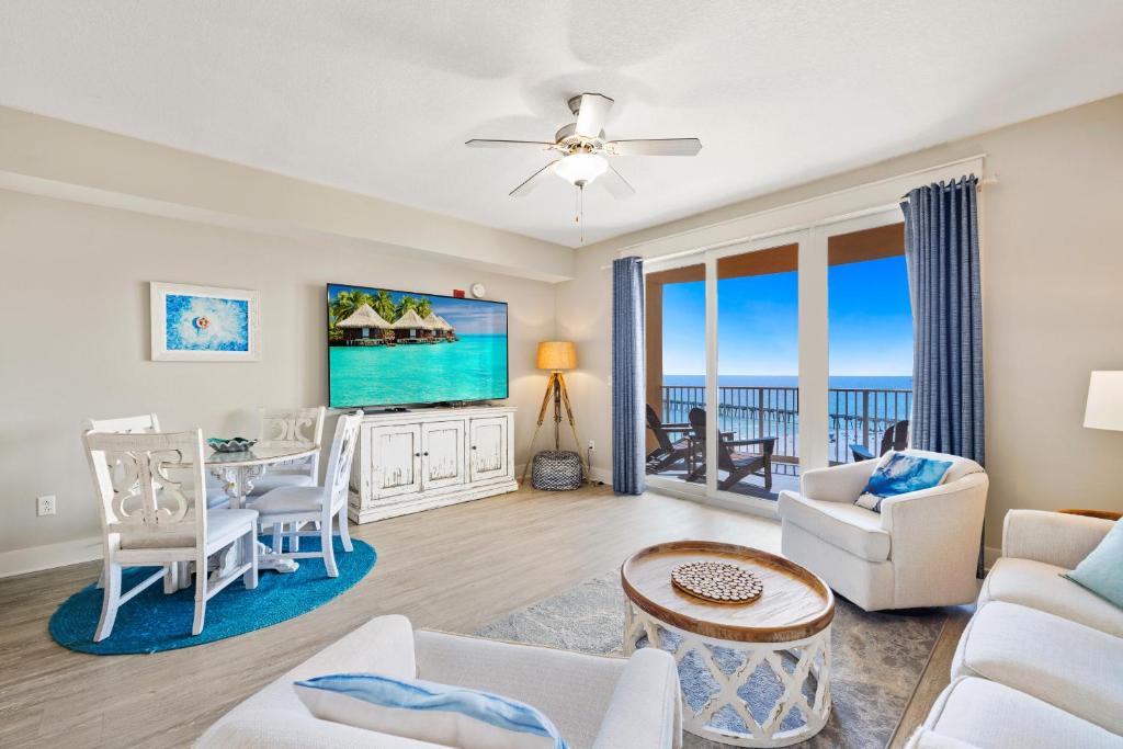 a living room with a view of the ocean at Calypso Tower 3 - Endless Sunsets and Gulf Coast View! in Panama City Beach
