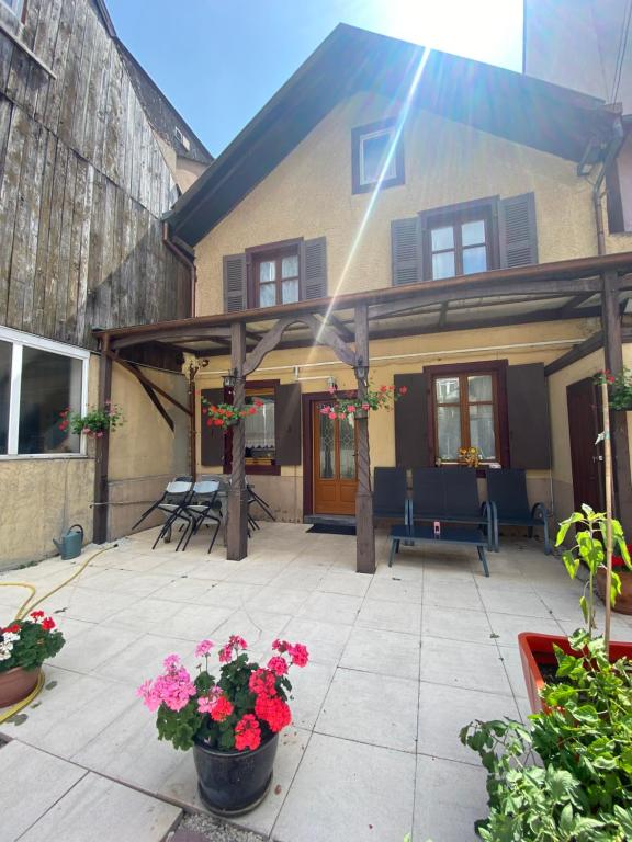 a patio with flowers in front of a house at Maison avec terrasse Colmar Centre-Cottage garden terrace Center Old Town Colmar in Colmar