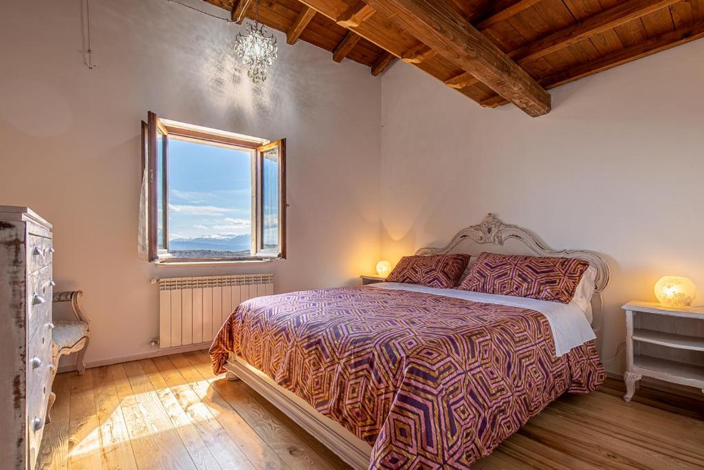 a bedroom with a bed and a window at Cuore Nero Food and Relax in Santo Stefano di Sessanio