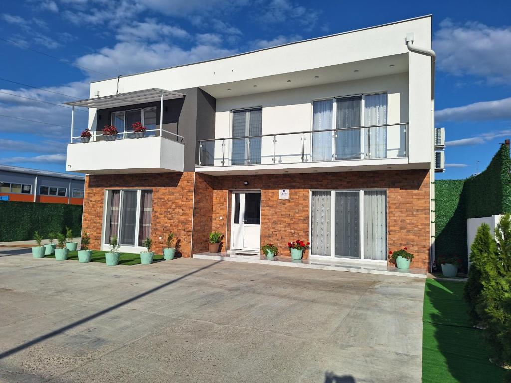 a large brick house with a balcony at Apartmani KOKI Kladovo in Kladovo