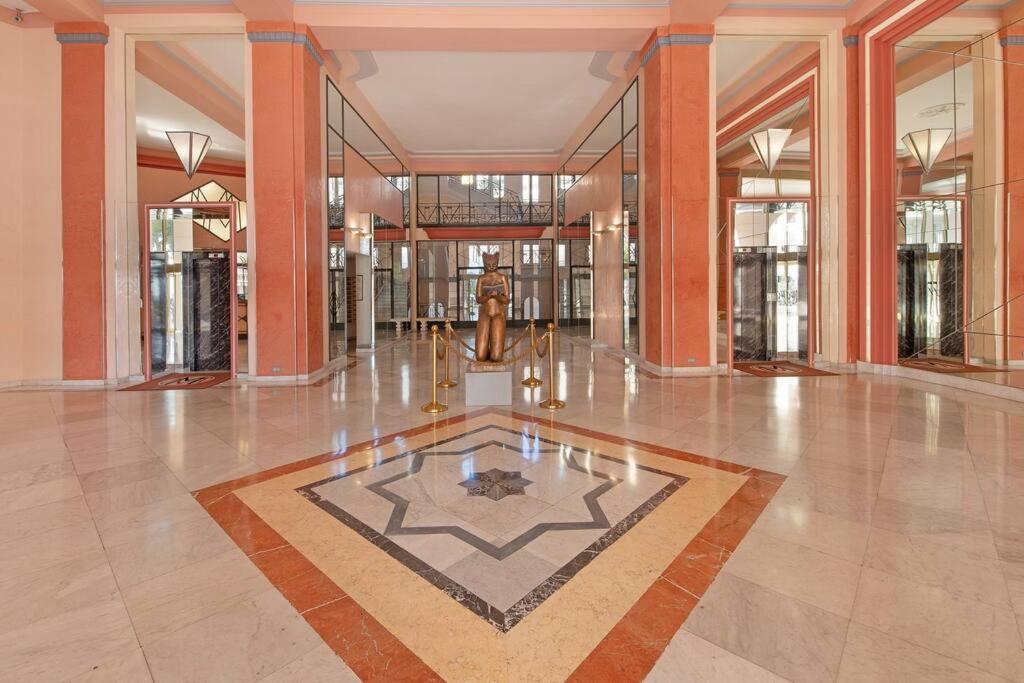 an empty lobby with a fountain in the middle of a building at Palais Miramar - Suite White Jardin - 20m Plage in Cannes