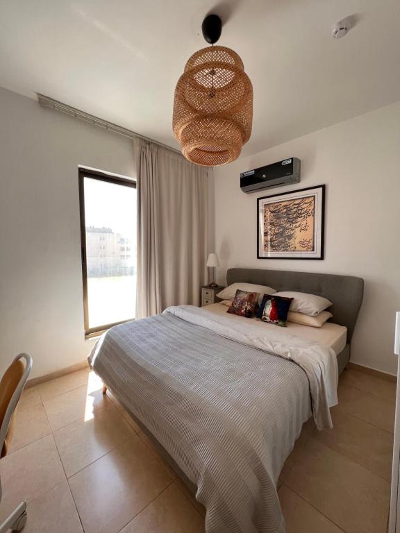 a bedroom with a large bed and a large window at The Arabian Oryx in Amman