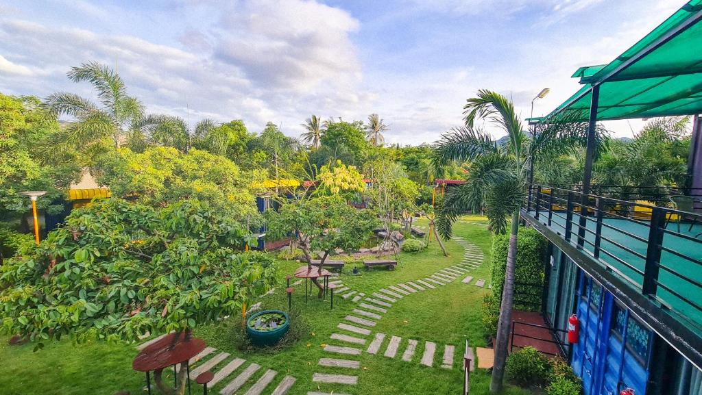 a view of a garden from a balcony at Beach Box at Pran in Sam Roi Yot