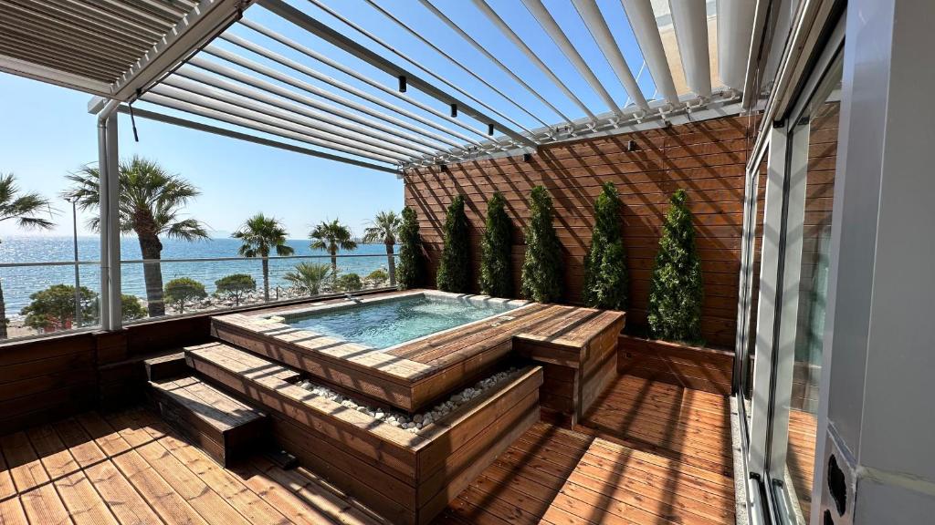 a hot tub on a balcony with a view of the ocean at Belleview Apartment in Vlorë
