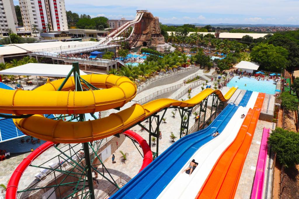 an amusement park with a roller coaster and a water park at Lacqua diRoma com acesso Acqua Park, Splash e Slide in Caldas Novas
