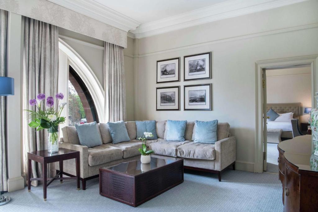 a living room with a couch and a table at The Caledonian Edinburgh, Curio Collection by Hilton in Edinburgh