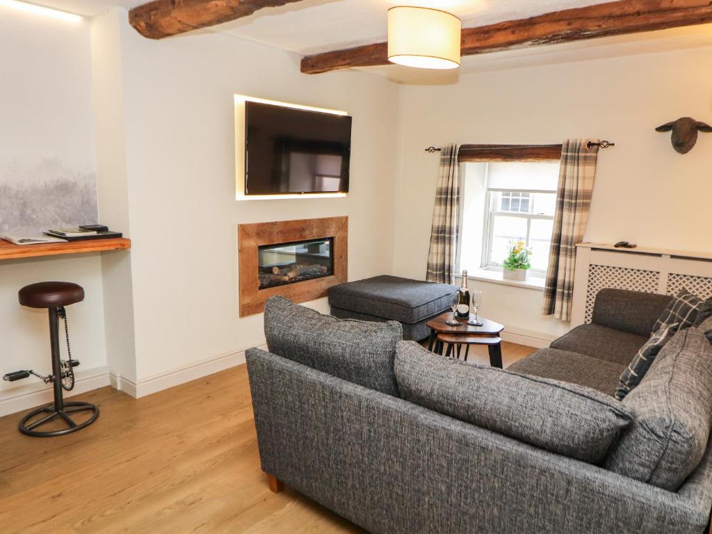 a living room with a couch and a fireplace at Tawny Owl in Carnforth