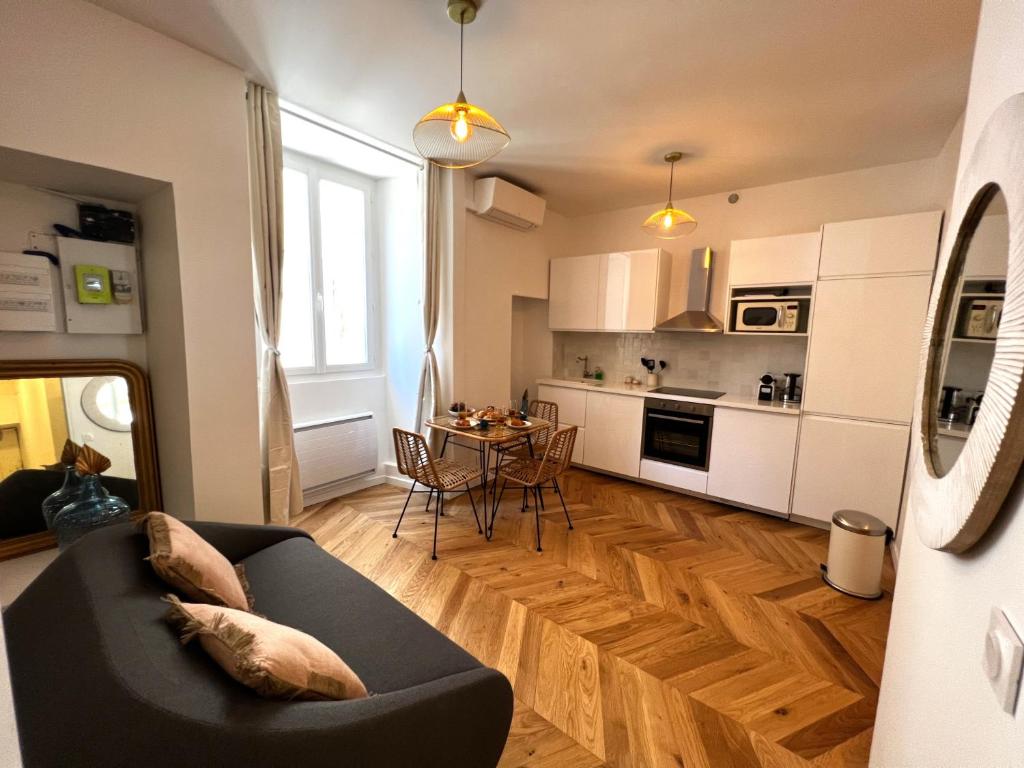 a living room with a couch and a table at Le Petit Palais Notre Dame - Heart of Dijon in Dijon