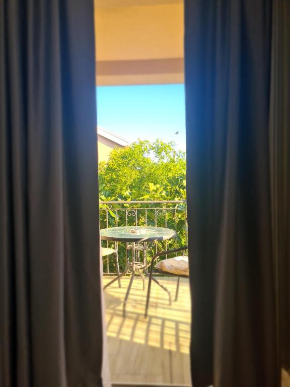 a view from a window of a patio with a table at Casa M 1 in Donja Lastva
