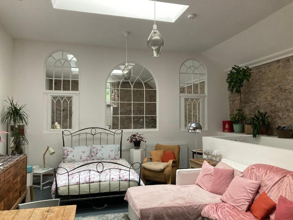 a living room with a bed and a couch at ‘Museum Loft’ Scotland’s Wee Hat Museum in Newburgh