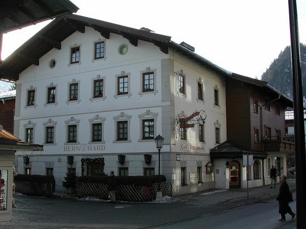 a large white building on the side of a street at Hotel Garni Bernhard am See in Walchsee
