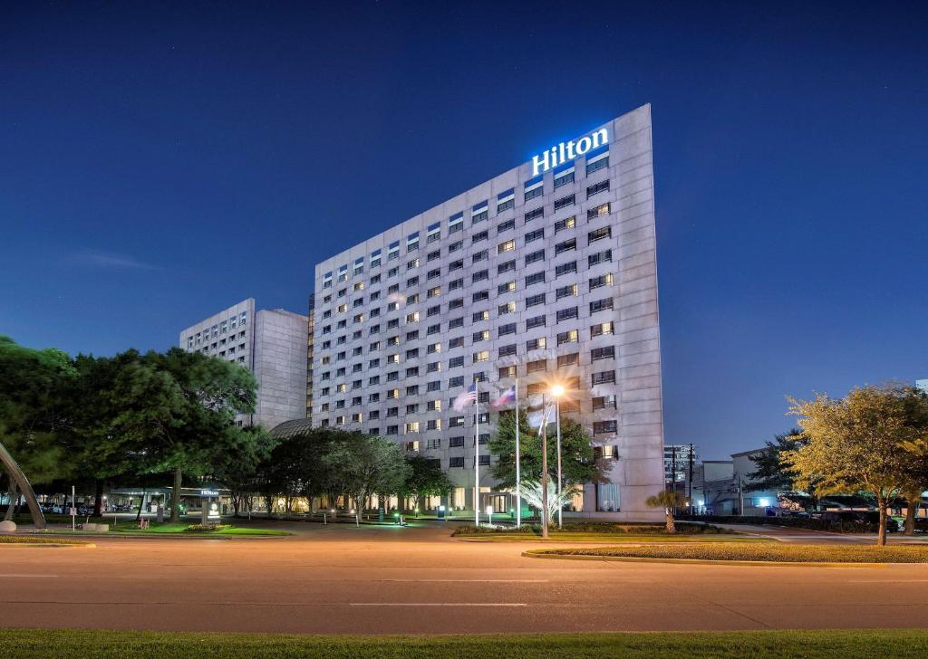 a hotel building with a lit up sign on it at Hilton Houston Post Oak by the Galleria in Houston